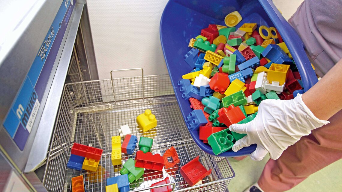 Toy bricks are put into the TopClean 60 from Meiko to be cleaned