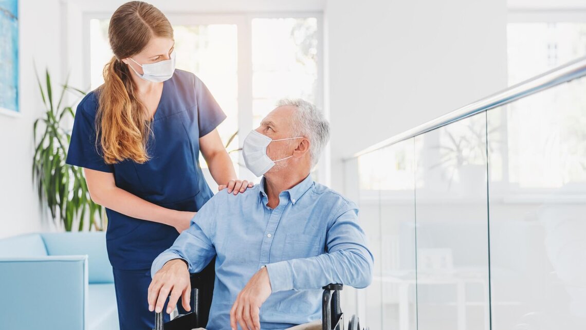 A carer using a mask to protect herself from pathogen transmission